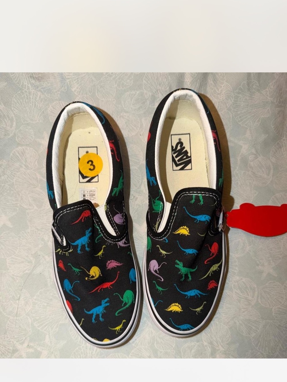 Vans Kids Black Slip-On Sneakers with Multicolor Dinosaur Pattern